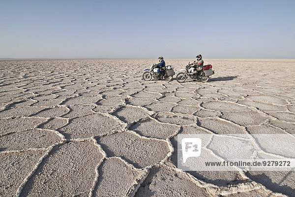 Biker on a motorcycle trip  Dasht-e Kavir or Great Salt Desert  Marenjab  Maranjab  Semnan Province  Iran