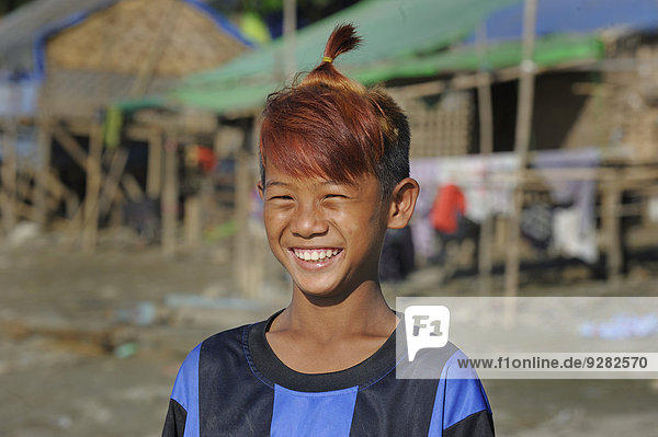 Boy from the slums with dyed hair and fashionable hairstyle  Irrawaddy  Mandalay  Mandalay District  Myanmar