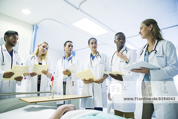 Doctor teaching residents in hospital room