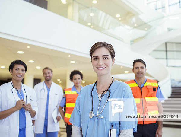 Doctors  nurses and paramedics smiling in hospital