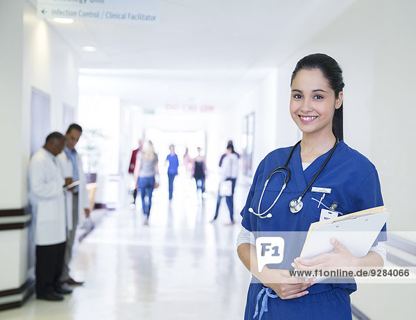 Nurse smiling in hospital hallway