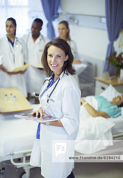 Doctor holding digital tablet in hospital room
