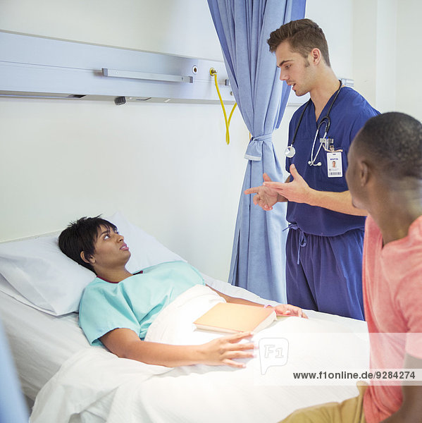 Nurse talking to patient in hospital room
