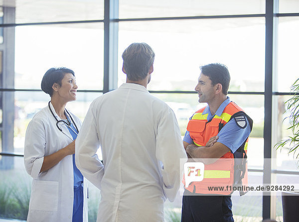 Doctors and paramedic talking in hospital
