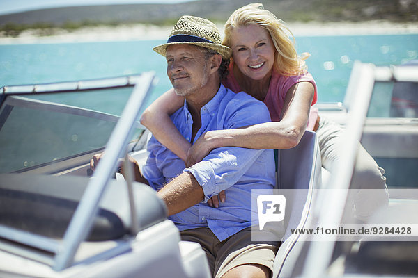 Older couple relaxing on boat
