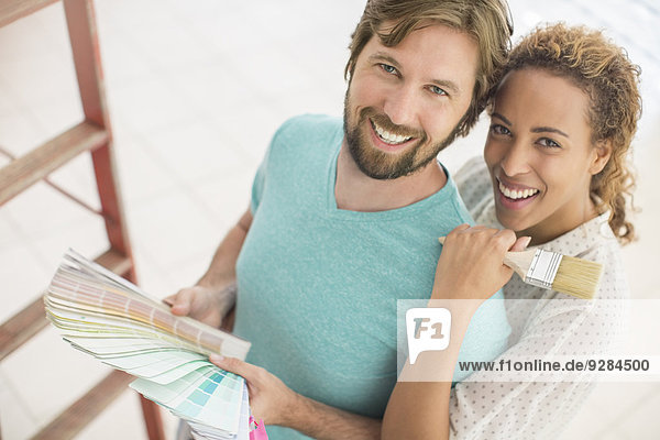Couple looking through paint swatches together