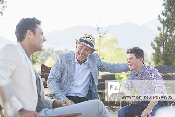 Three generations of men relaxing outdoors