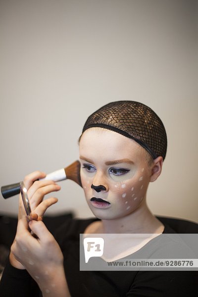 Woman doing stage make-up