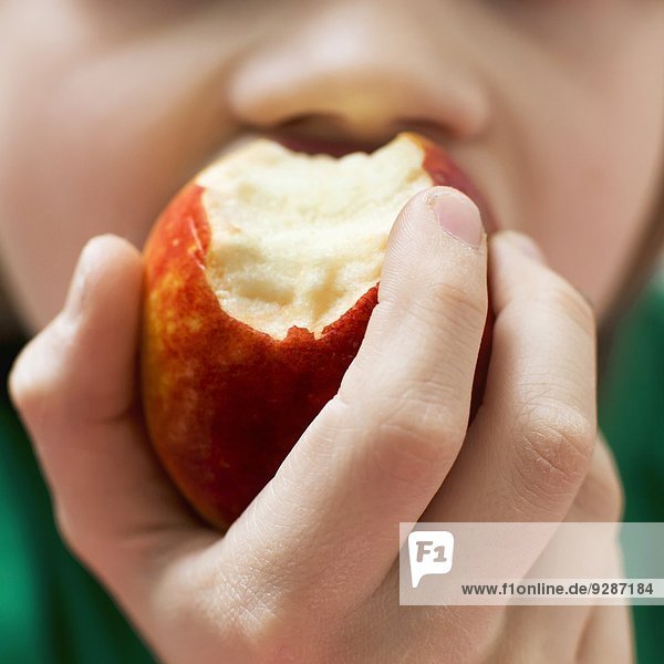 Boy eating apple  close-up