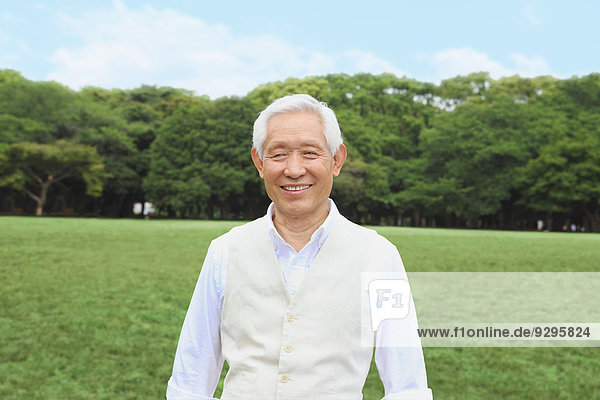 Senior adult Japanese man in a park