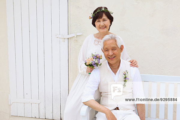 Senior adult Japanese couple celebrating