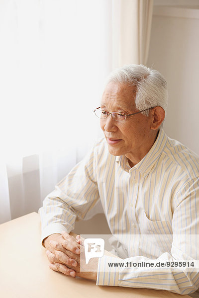 Senior adult Japanese man sitting