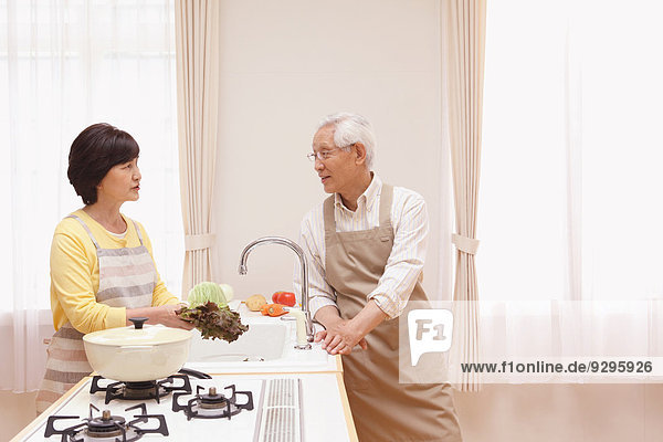 Senior adult Japanese couple in the kitchen