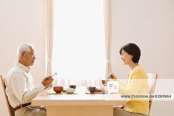 Senior adult Japanese couple in the kitchen