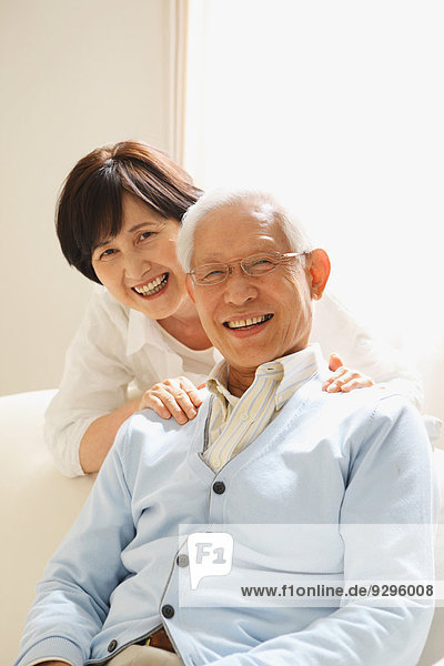 Senior adult Japanese couple on the sofa