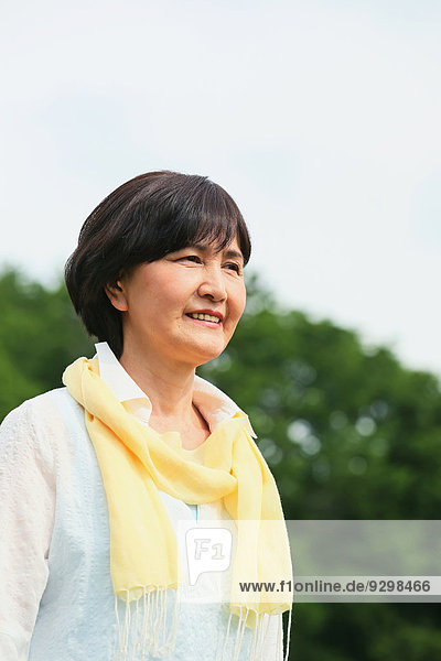 Senior adult Japanese woman in a park