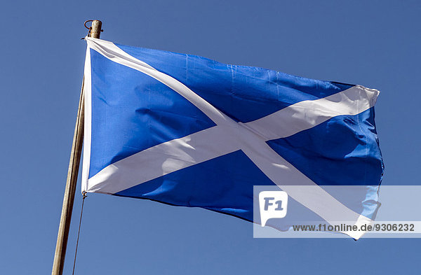 The Saltire  Scottish flag  flying against a blue sky  Oban  Scotland  United Kingdom