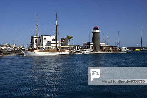Excursion boat for tourists  former lighthouse  Marina Rubicon  Playa Blanca  Lanzarote  Canary Islands  Spain