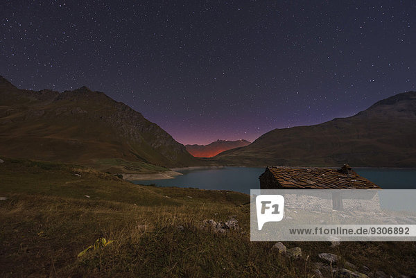 Night sky above Mont Cenis lake and a hut  Savoie  France