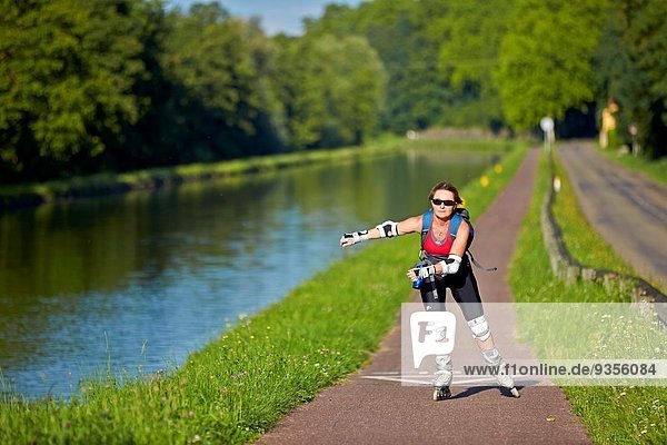 France Bas-Rhin Dettwiller Woman rollerblading along the Canal from the Marne to the Rhine.