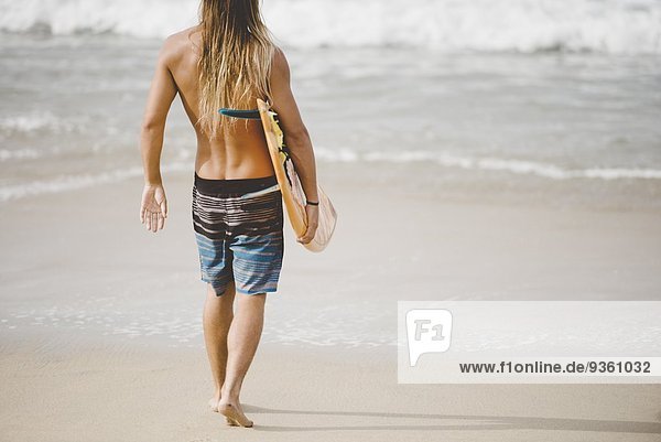Australian surfer with surfboard  Bacocho  Puerto Escondido  Mexico