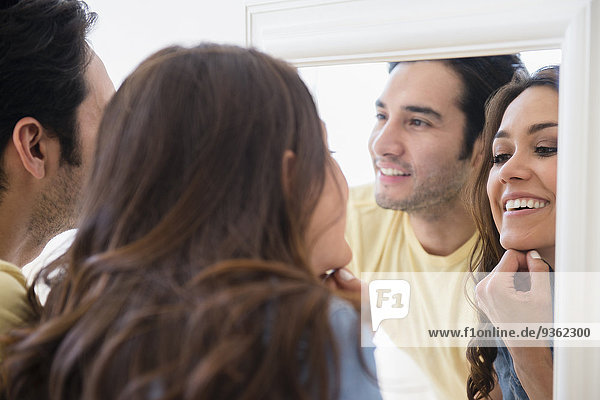 Couple admiring themselves in mirror