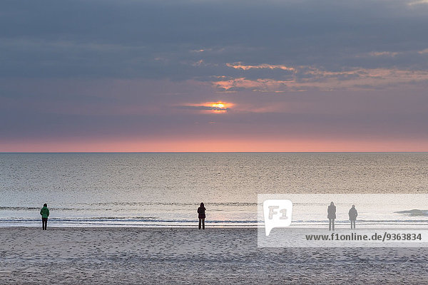 Germany  Schleswig-Holstein  Sylt  North Sea  sunset on the beach  four people