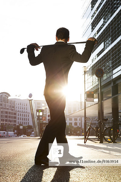 Germany  Berlin  Businessman cross golfing