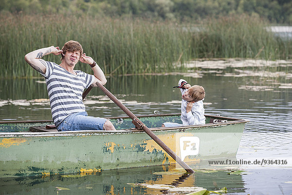 Germany  Rhineland-Palatinate  Laacher See  playful father and son in boat
