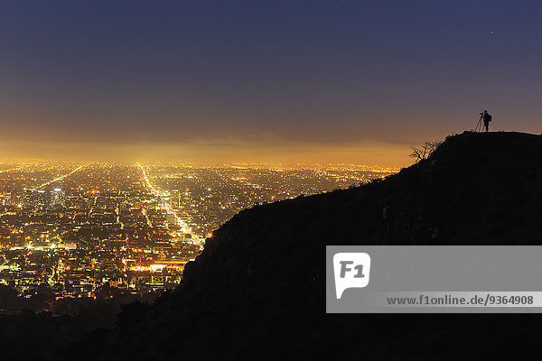 USA  California  Los Angeles  Cityscape and photographer on a mountain
