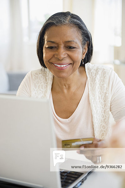 Mixed race woman shopping on laptop