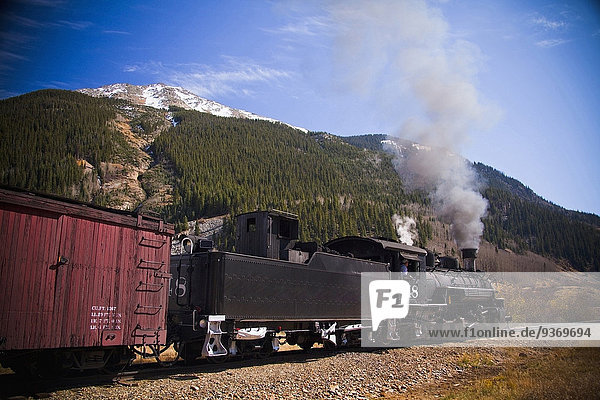 Steam train near mountain