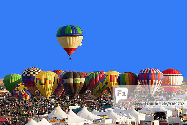 Hot air balloon floating above others at festival  Albuquerque  New Mexico  United States