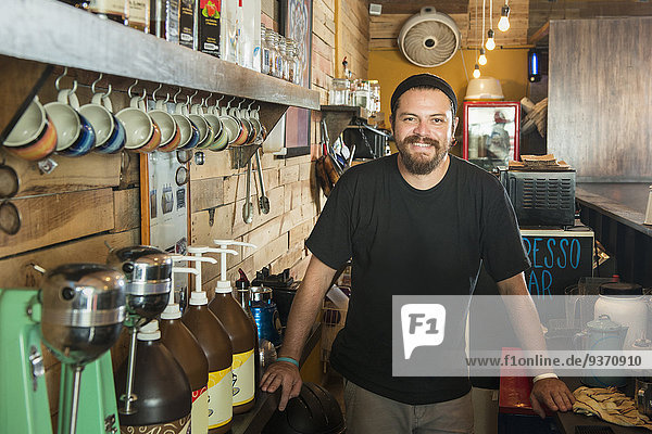 Hispanic man working in coffee shop