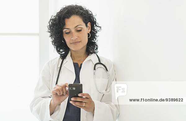 Female doctor using cell phone