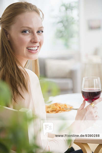 Woman having meal with red wine