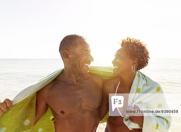 Mature couple embracing on beach