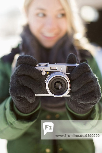 Woman holding old-fashioned camera
