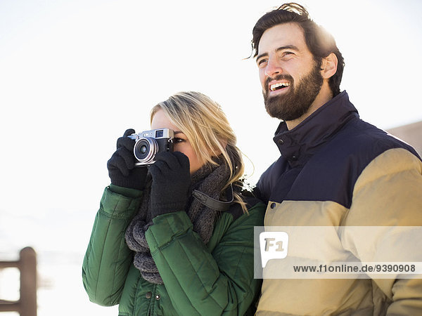 Couple photographing winter landscape