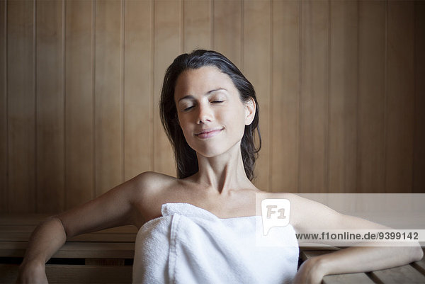 Woman getting away from it all in sauna