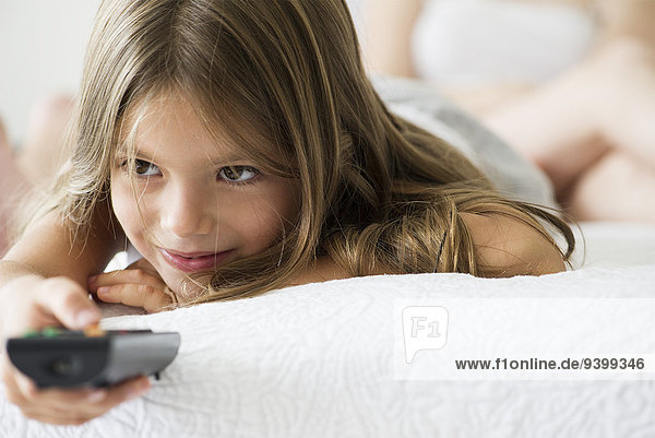 Little girl holding remote control