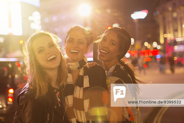 Women laughing together on city street