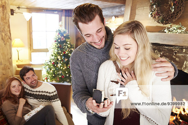 Man giving girlfriend jewelry for Christmas