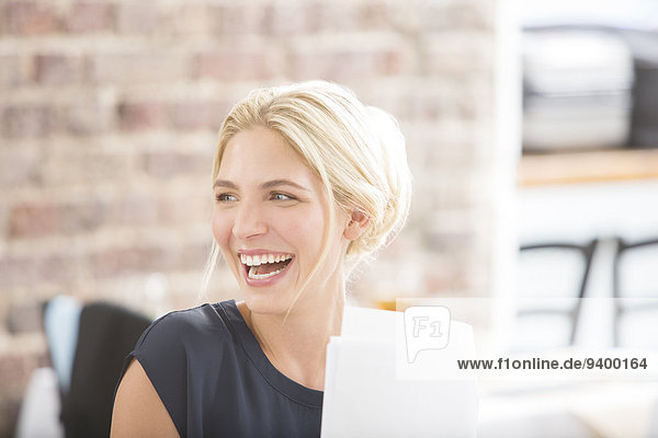 Woman laughing in office