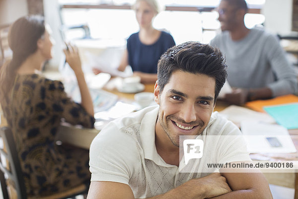 Businessman smiling at meeting in cafe