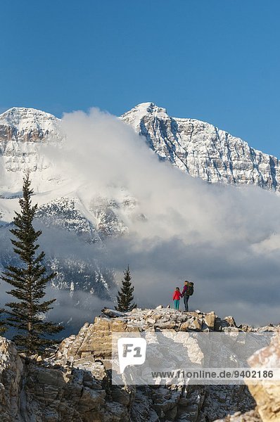A woman and her daughter hiking near the Saskatchewan River below the Canadian Rockies  Banff National Park  Alberta  Canada.