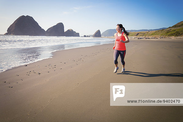 25-29 Years beach Brown Hair day Effort Full Length Healthy Lifestyle Horizontal Horizontal landscape Leisure Facilities Long Hair Non Urban Scene One Person one young woman only Oregon Oregon coast outdoors Ponytail Rock Formation Running sand Scenics S
