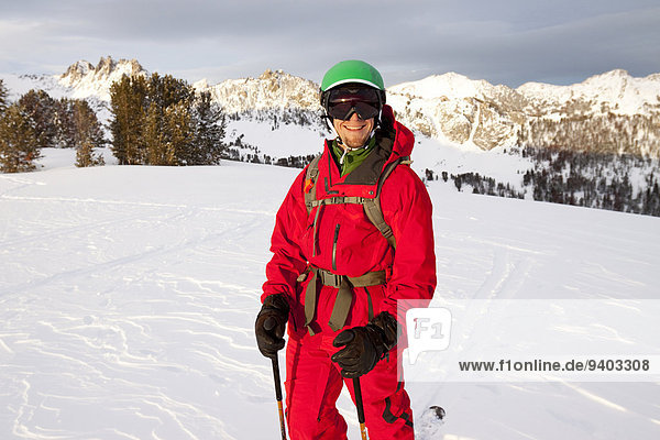 A male backcountry skier smiles after skiing in the Beehive Basin near Big Sky  Montana.