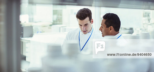 Scientists talking in laboratory