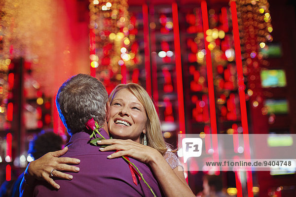 Frau und Mann umarmen sich im Nachtclub